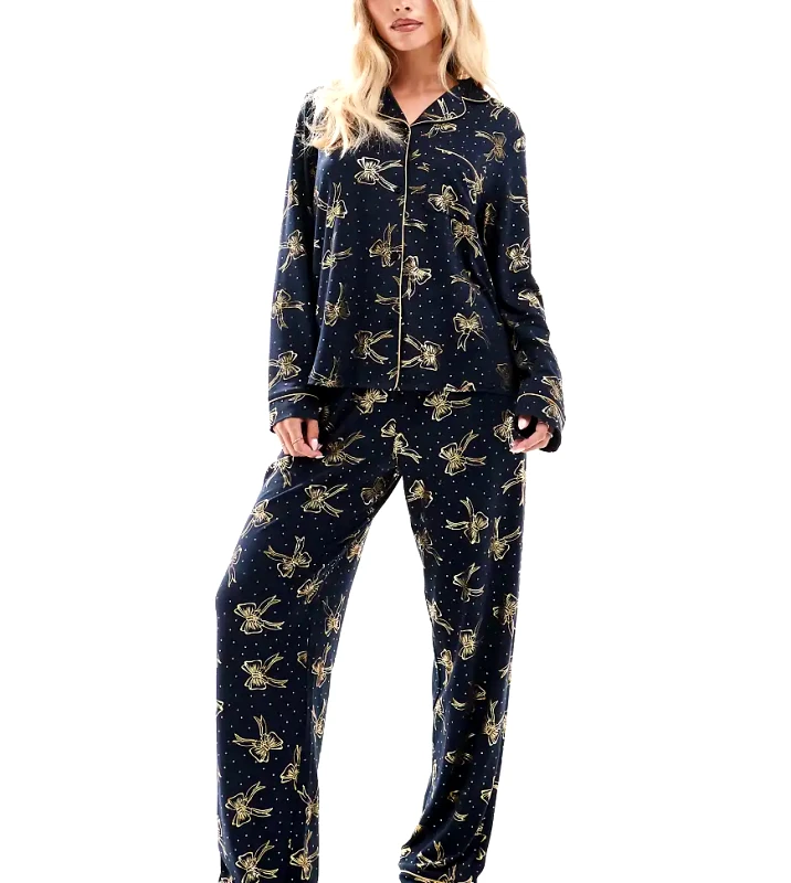Chelsea Peers Petite Chelsea Peers Petite poly Christmas foil bow print long sleeve revere and trouser pyjama set in navy